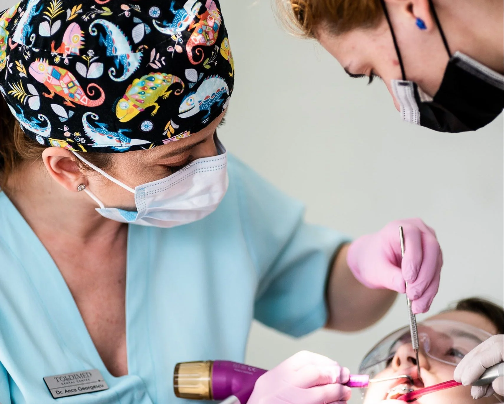 Două persoane lucrează la restaurări dentare, asistență dentară.